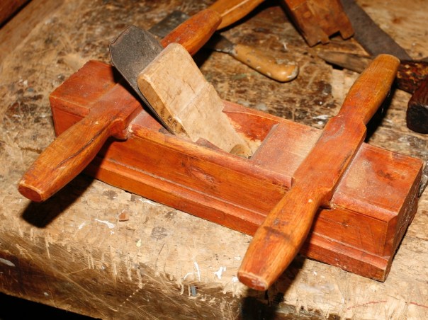 Skottokse i samlinga på Dølmotunet i Tolga. Høvelen er stempla med bokstavane EI, truleg er det bokstavane til snikkaren som har laga og brukt høvelen. Skottoksen er kring 12 " lang og kan høvle litt i overkant av 2" bredde. Høvelen har meiane laga av same stykke som høvelstokken. Foto: Roald Renmælmo